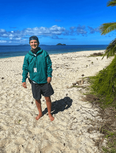 Student standing on beach