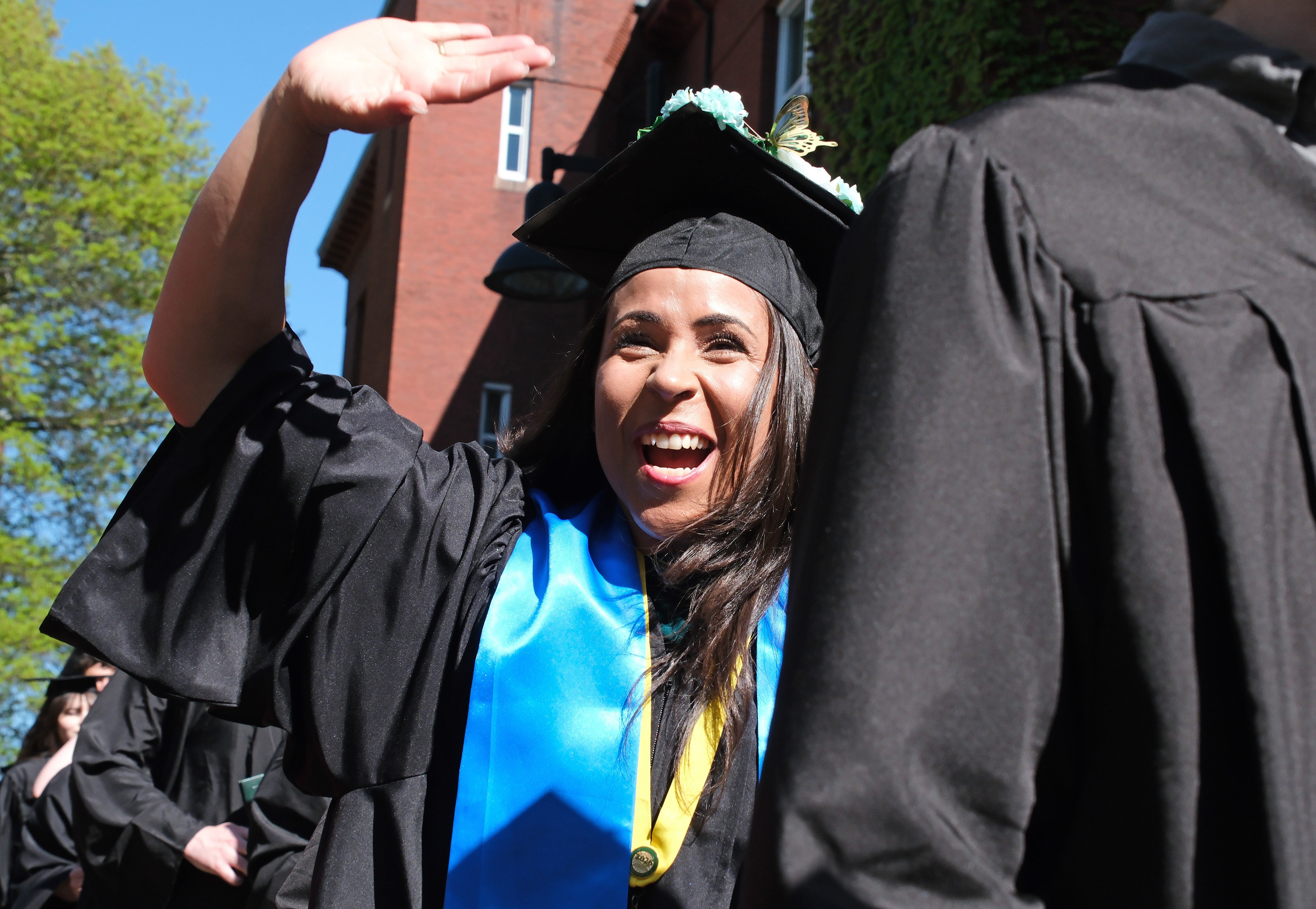 Undergrad smiling and waving